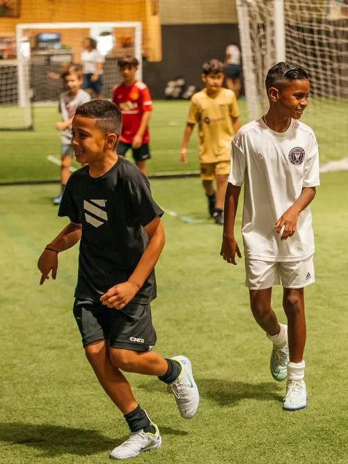 Kids participating in indoor soccer camp activities at AGS Youth Soccer in Fort Lauderdale