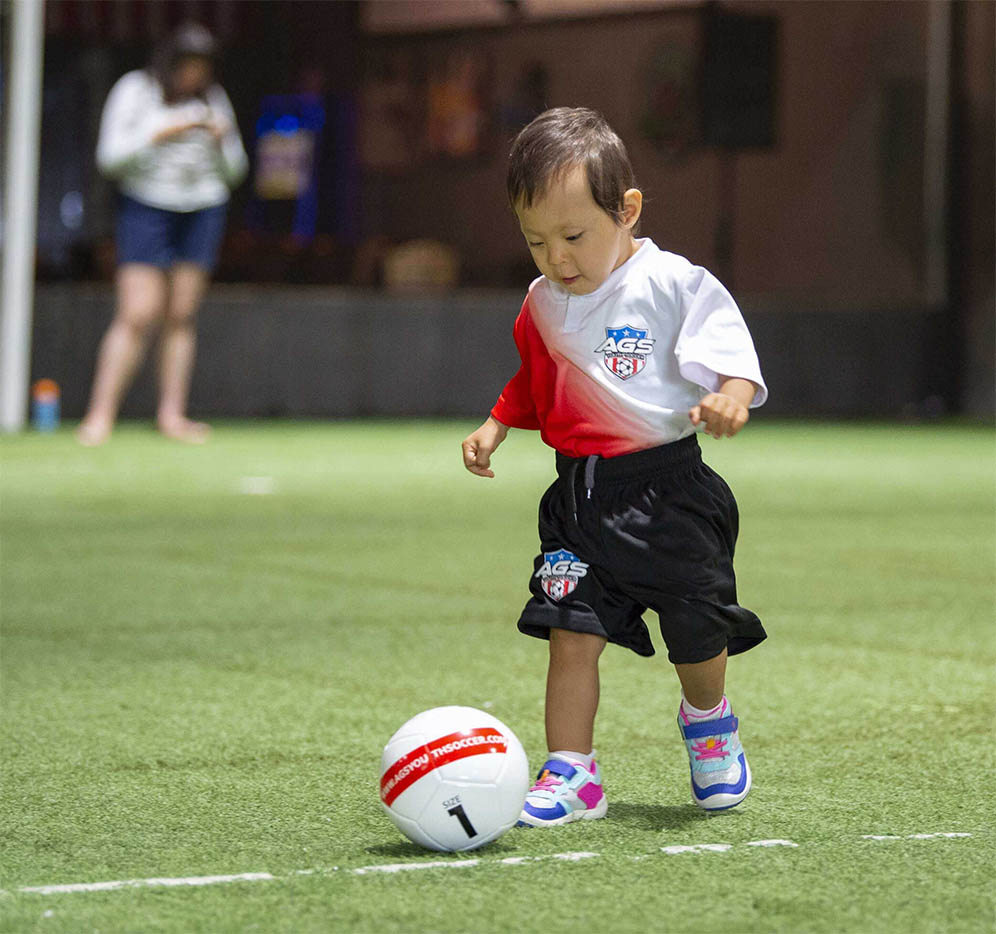 Youth Soccer League Player Scoring A Goal