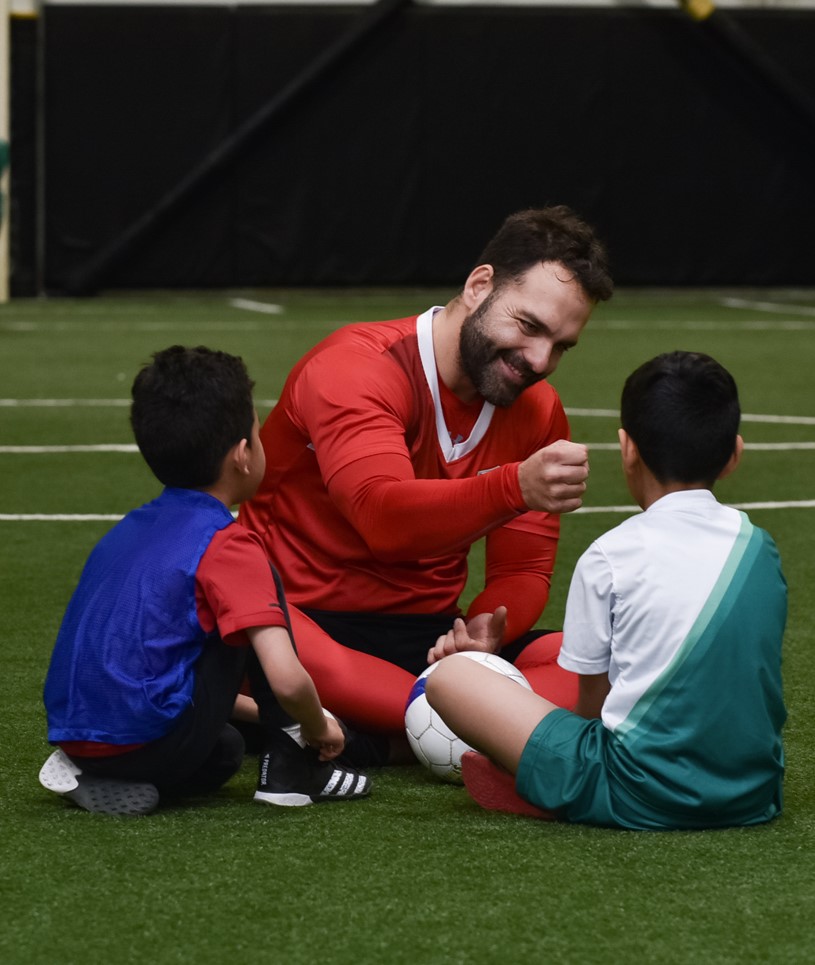 Image of Coach Fist Pumping a youth soccer player