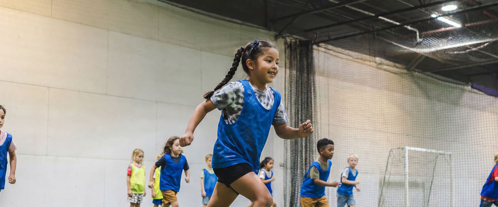 Kids participating in indoor soccer camp activities at AGS Youth Soccer in Fort Lauderdale