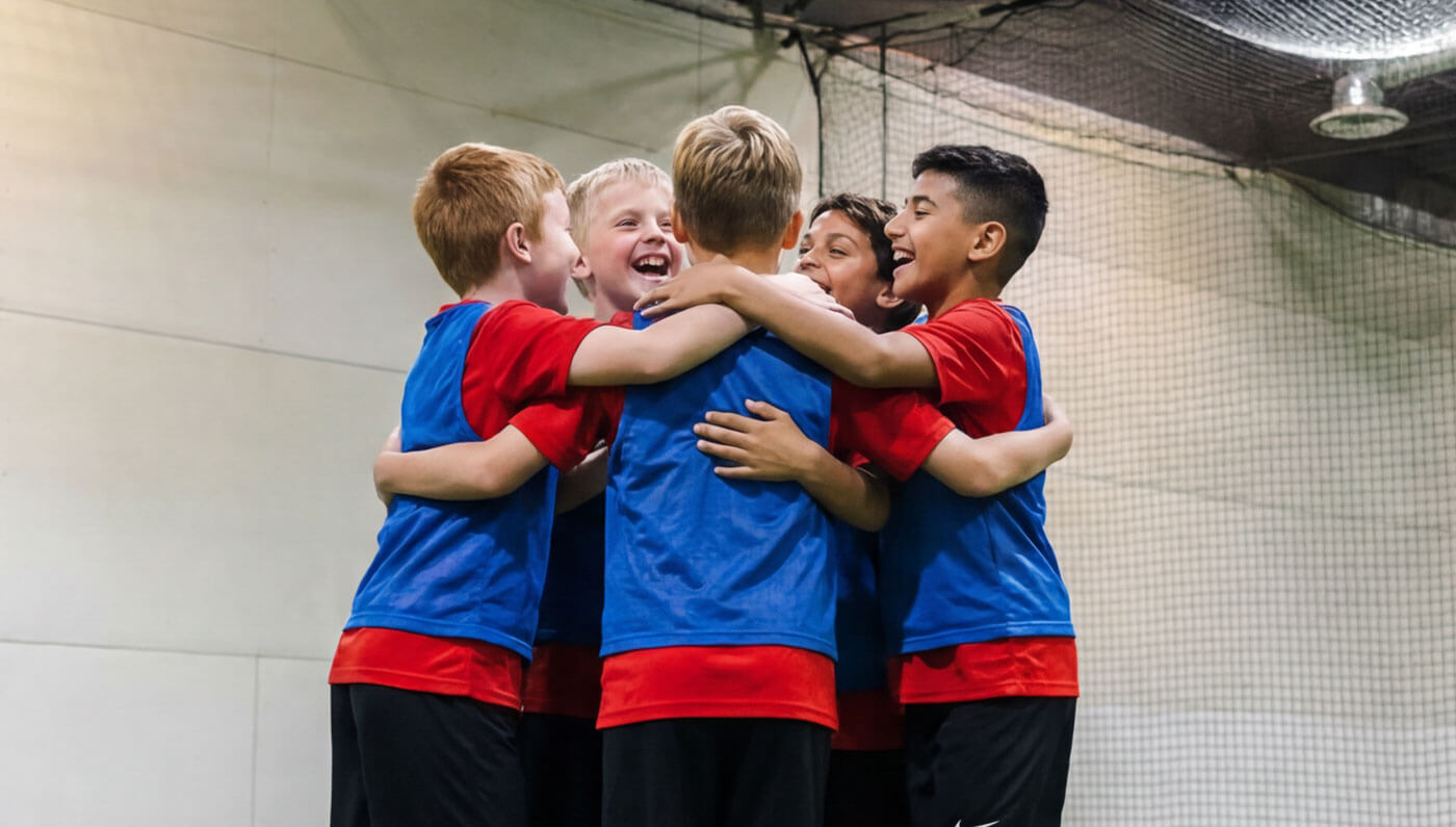 Youth players celebrating during an indoor soccer league game at AGS Youth Soccer in Fort Lauderdale